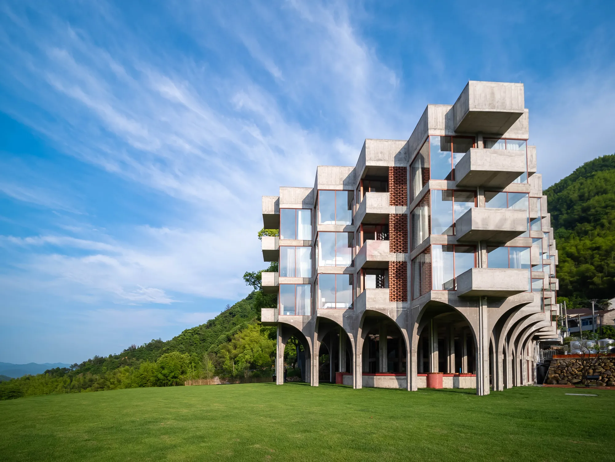 Architectural photograph of a concrete building on a hillside